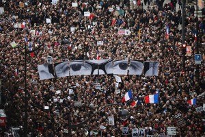PARIS, FRANCE - JANUARY 11: Demonstrators make their way along Boulevrd Voltaire in a unity rally in Paris following the recent terrorist attacks on January 11, 2015 in Paris, France. An estimated one million people are expected to converge in central Paris for the Unity March joining in solidarity with the 17 victims of this week's terrorist attacks in the country. French President Francois Hollande will lead the march and will be joined by world leaders in a sign of unity. The terrorist atrocities started on Wednesday with the attack on the French satirical magazine Charlie Hebdo, killing 12, and ended on Friday with sieges at a printing company in Dammartin en Goele and a Kosher supermarket in Paris with four hostages and three suspects being killed. A fourth suspect, Hayat Boumeddiene, 26, escaped and is wanted in connection with the murder of a policewoman. (Photo by Christopher Furlong/Getty Images)